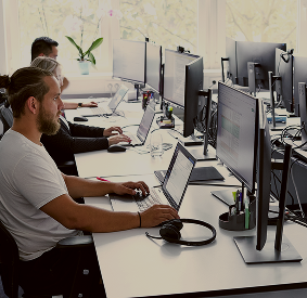 People working at computer desks.
